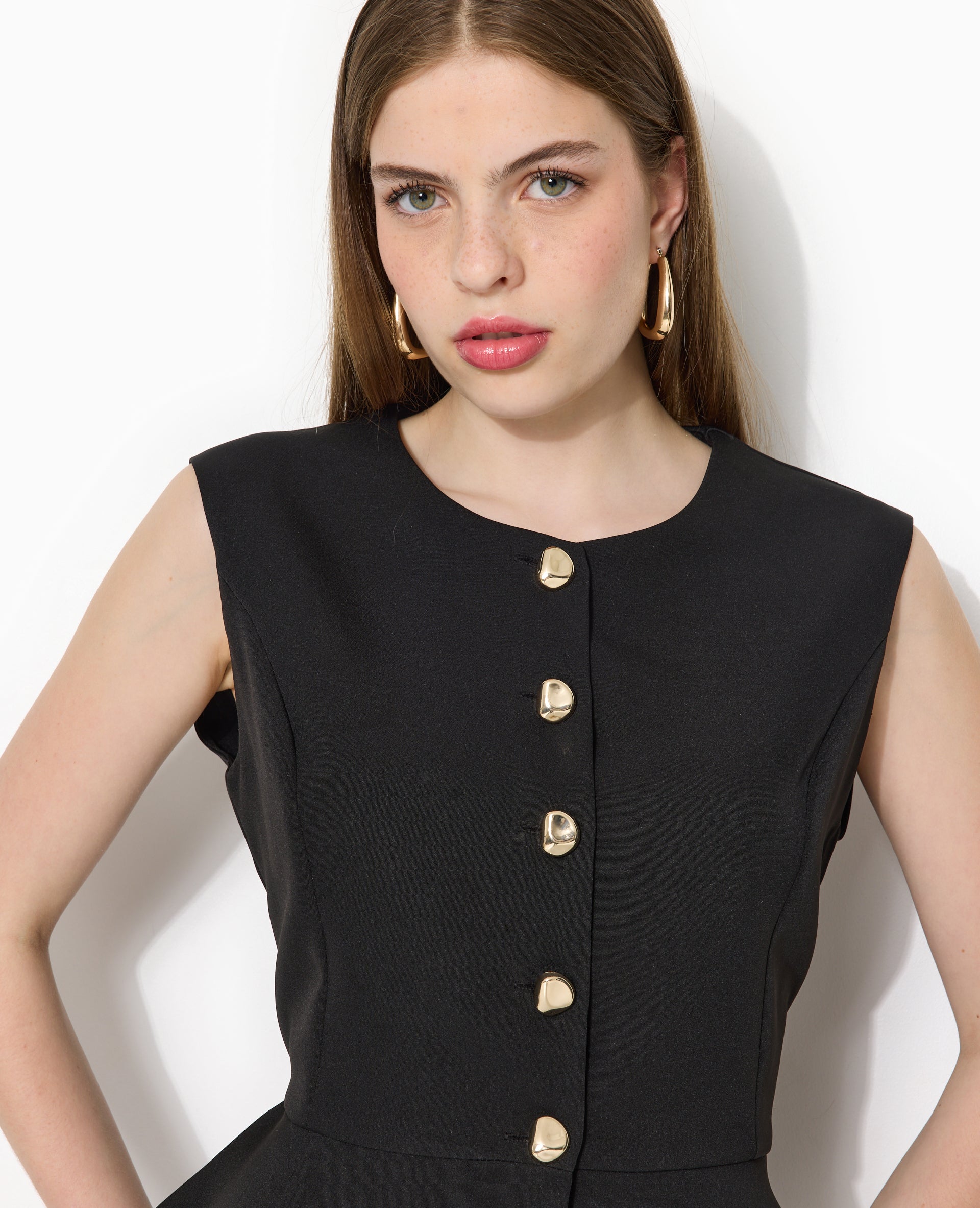 Veste sans manches peplum avec boutons fantaisie