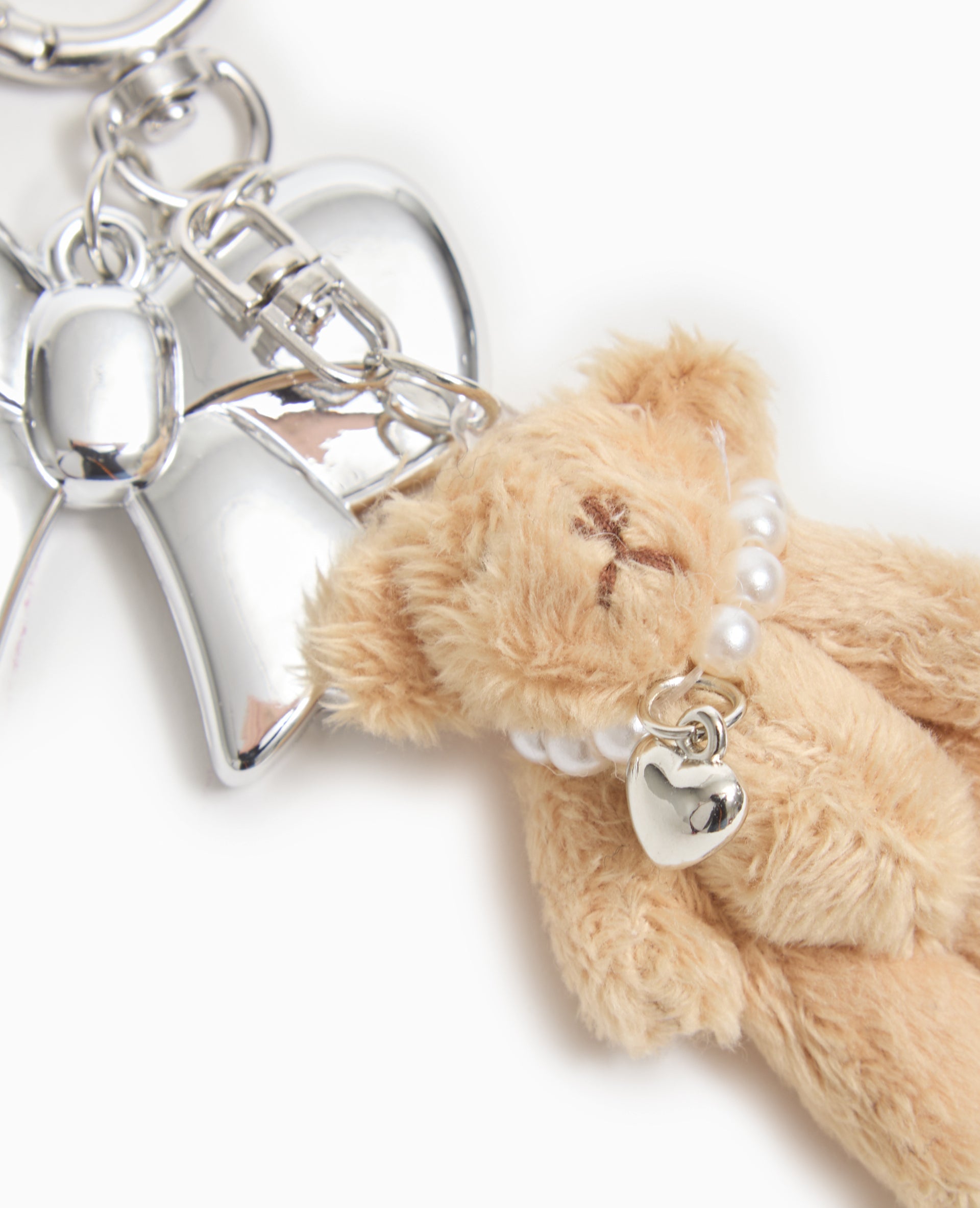 Porte-clé avec mini-peluche et nœud métal